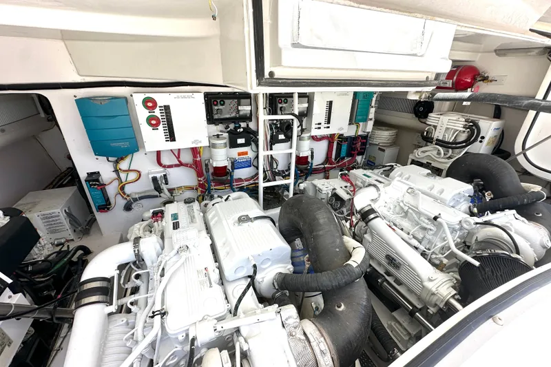 Slide: The Image of Engine room of a 2012 Viking 42 Open yacht, showcasing dual engines and control systems. - 34