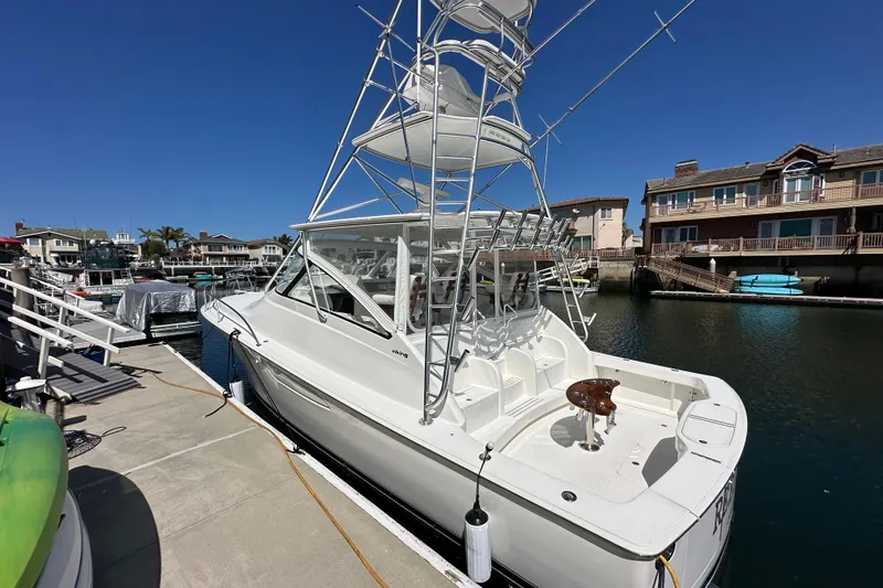 Slide: The Image of 2012 Viking 42 Open yacht docked at marina under clear blue sky. - 35
