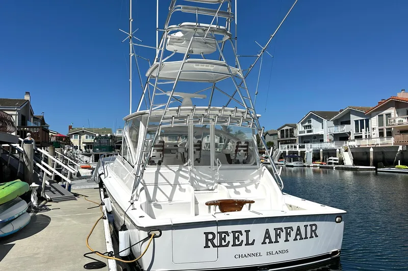 Slide: The Image of 2012 Viking 42 Open yacht docked at marina, clear blue sky, waterfront homes. - 5
