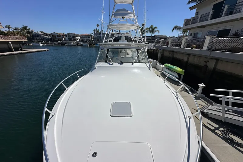 Slide: The Image of 2012 Viking 42 Open yacht docked in a serene marina setting. - 6