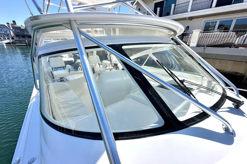 Slide: The Image of 2012 Viking 42 Open yacht with sleek design, docked by waterfront homes. - 9