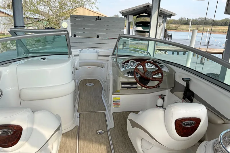 Slide: The Image of Interior of a 2007 Crownline 252 EX boat with steering wheel and seating. - 10