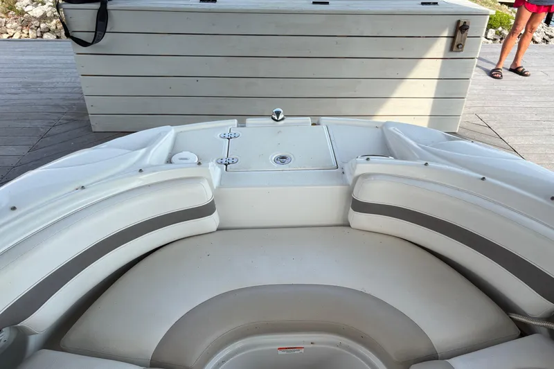Slide: The Image of 2007 Crownline 252 EX boat interior with white seating and storage compartment. - 13