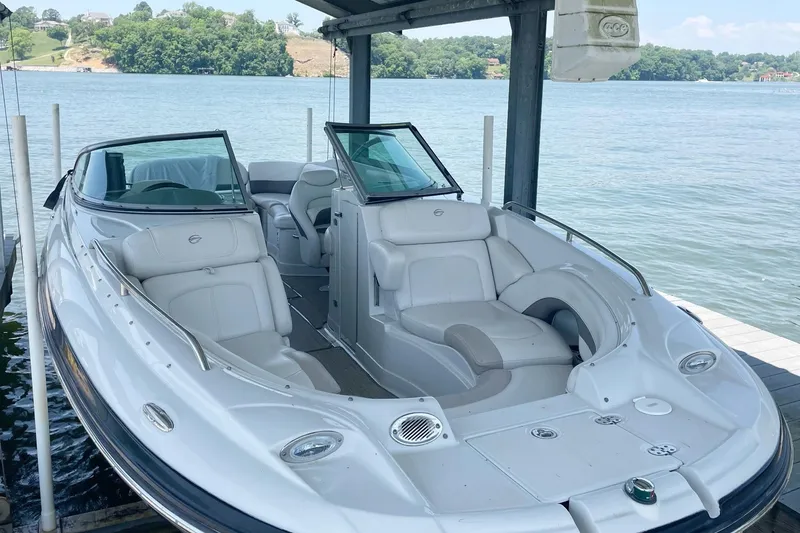 Slide: The Image of 2007 Crownline 252 EX boat docked on a serene lake. - 14