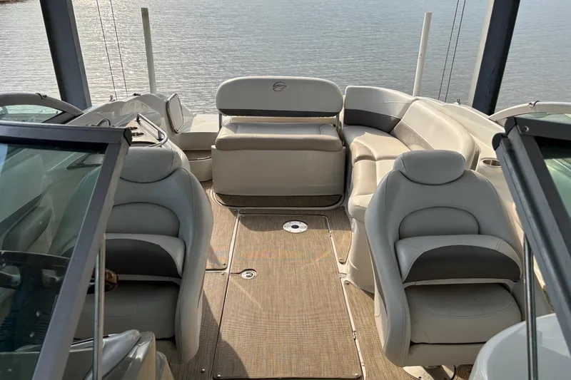 Slide: The Image of 2007 Crownline 252 EX boat interior with plush seating and lake view. - 16