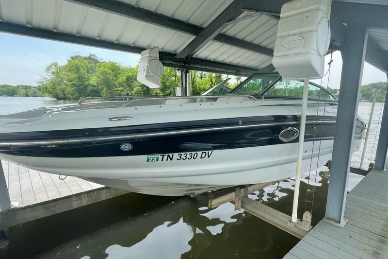 Slide: The Image of 2007 Crownline 252 EX boat docked under a covered marina on a lake. - 4