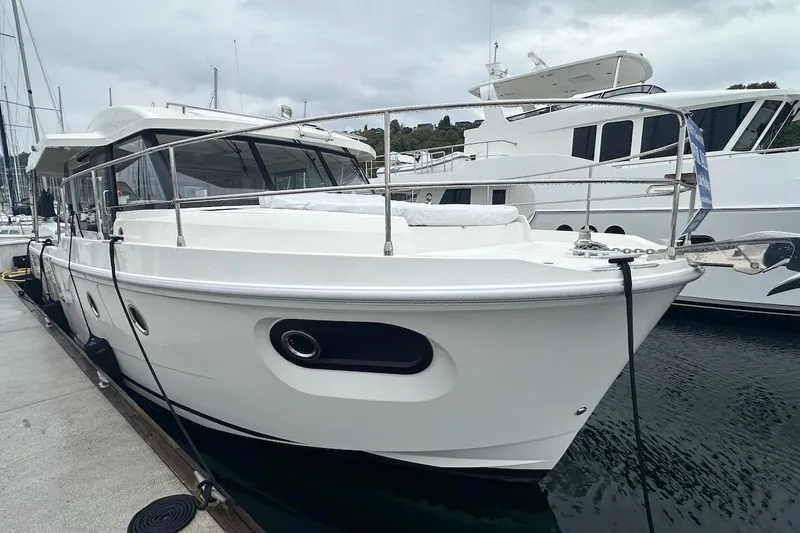 Slide: The Image of 2024 Beneteau Swift Trawler 41 Sedan docked at marina, side view. - 15