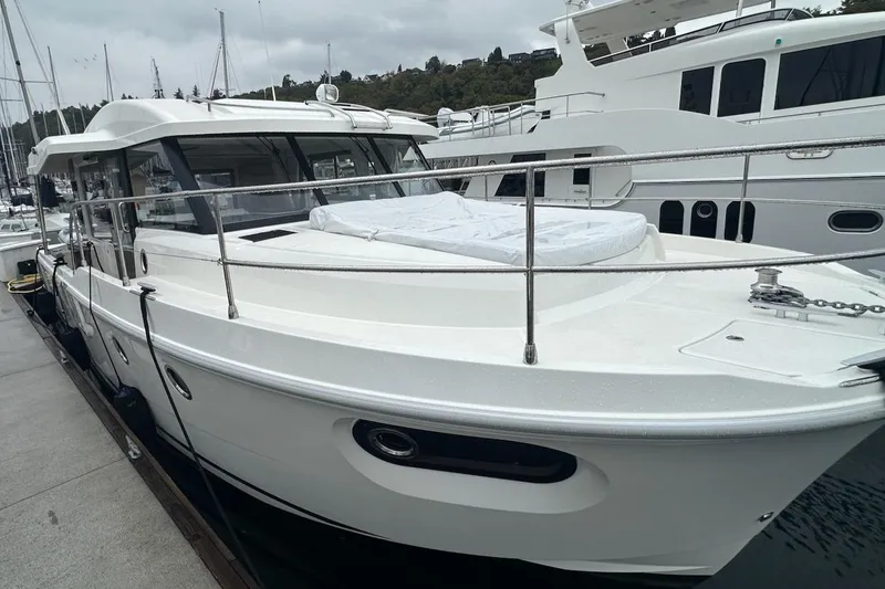 Slide: The Image of 2024 Beneteau Swift Trawler 41 Sedan docked at marina, showcasing sleek design. - 16