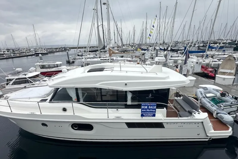 Slide: The Image of 2024 Beneteau Swift Trawler 41 Sedan docked, available for sale at marina. - 17