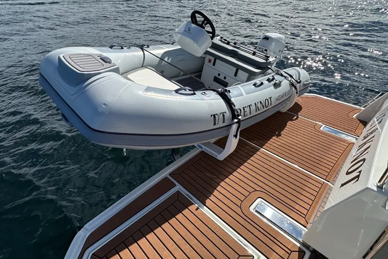 Slide: The Image of Inflatable dinghy on Beneteau Swift Trawler 41 Sedan, 2024 model, docked on teak platform. - 25