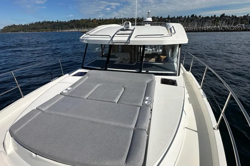 Slide: The Image of 2024 Beneteau Swift Trawler 41 Sedan on water, featuring spacious deck and sleek design. - 31