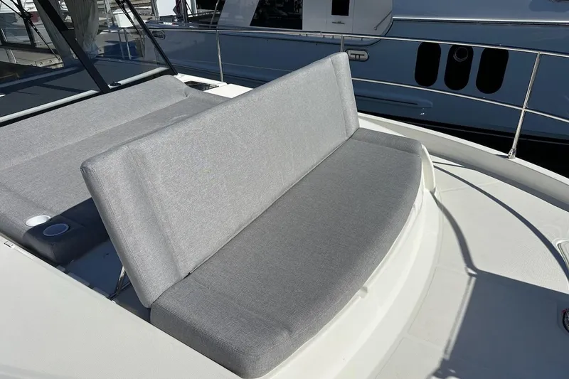 Slide: The Image of 2024 Beneteau Swift Trawler 41 Sedan, gray cushioned seating on deck. - 32