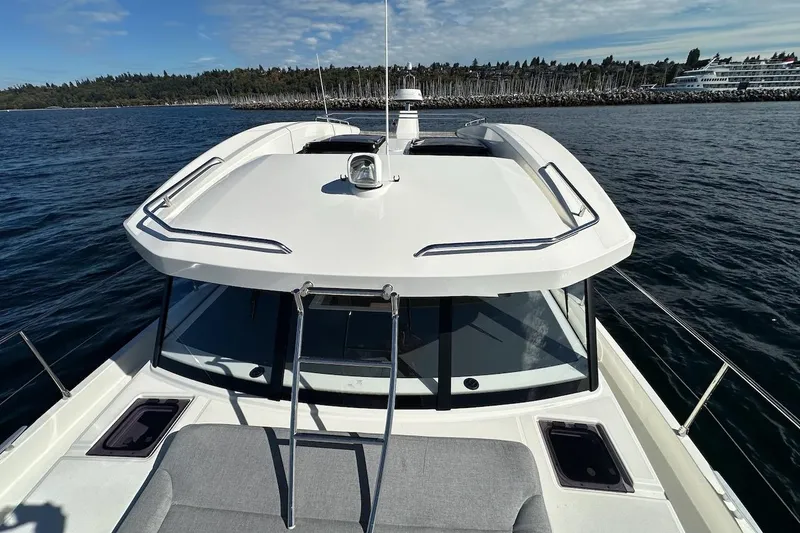 Slide: The Image of 2024 Beneteau Swift Trawler 41 Sedan cruising on open water, showcasing sleek design. - 33