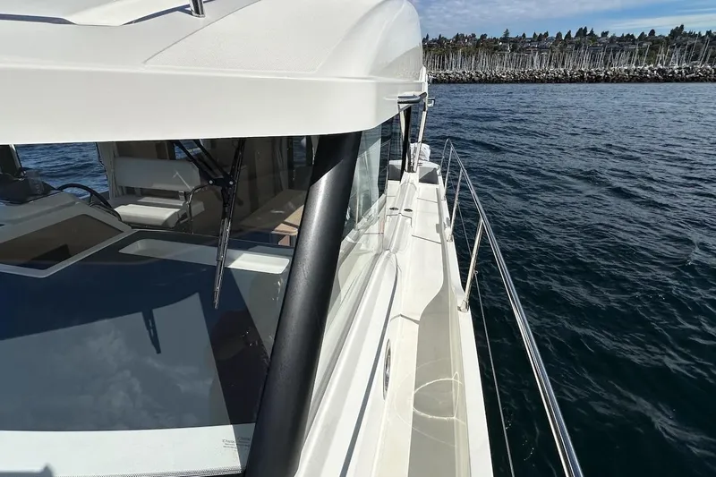 Slide: The Image of 2024 Beneteau Swift Trawler 41 Sedan cruising on open water, showcasing sleek design and spacious deck. - 35