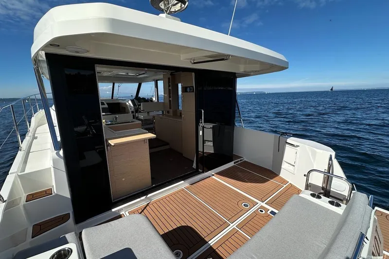 Slide: The Image of 2024 Beneteau Swift Trawler 41 Sedan on open water, showcasing spacious deck and interior. - 37