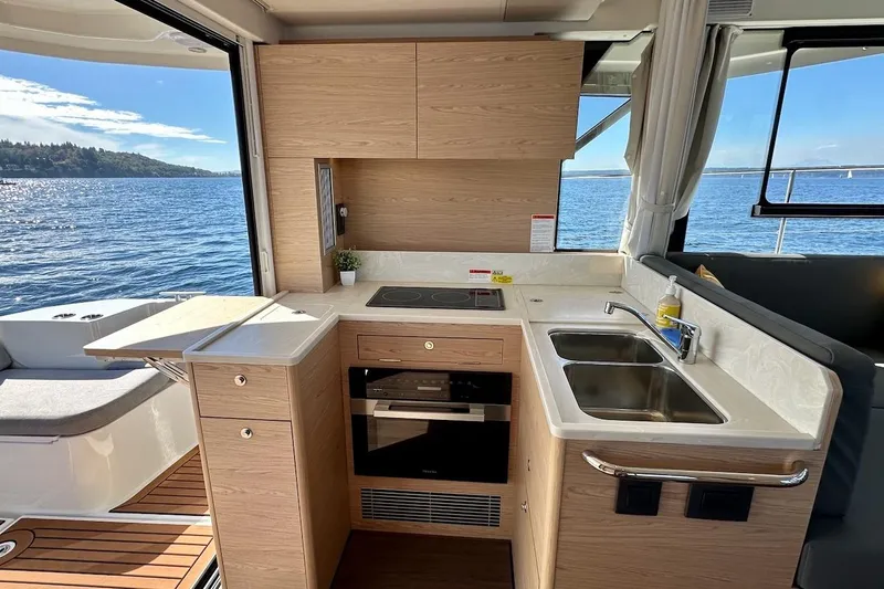 Slide: The Image of Modern kitchen interior on 2024 Beneteau Swift Trawler 41 Sedan, overlooking scenic ocean view. - 41