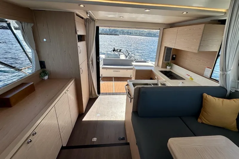 Slide: The Image of Interior of 2024 Beneteau Swift Trawler 41 Sedan with modern kitchen and seating area. - 46