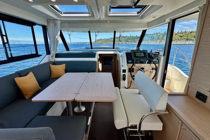 Slide: The Image of Interior of 2024 Beneteau Swift Trawler 41 Sedan with ocean view and modern furnishings. - 52