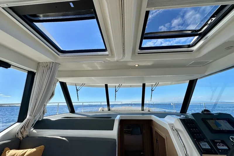 Slide: The Image of Interior view of 2024 Beneteau Swift Trawler 41 Sedan with panoramic windows and skylights. - 54