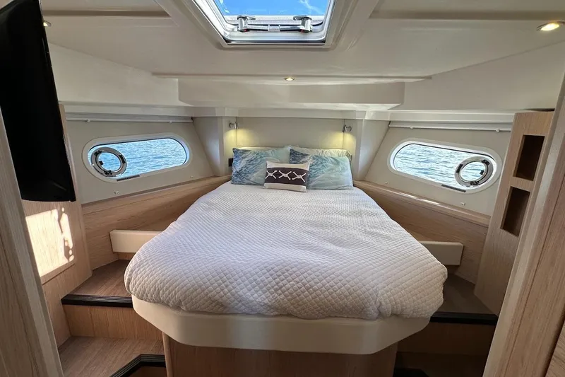 Slide: The Image of Luxurious cabin interior of 2024 Beneteau Swift Trawler 41 Sedan with cozy bedding. - 62