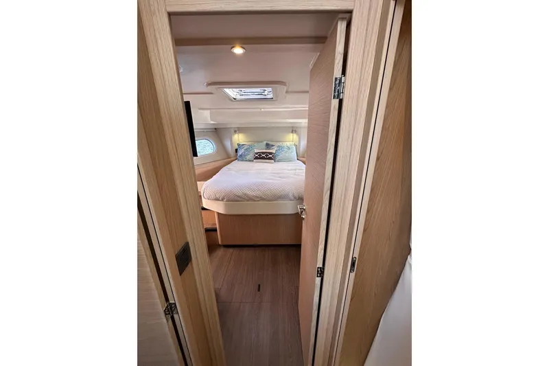 Slide: The Image of 2024 Beneteau Swift Trawler 41 Sedan cabin interior with cozy bed and modern design. - 63