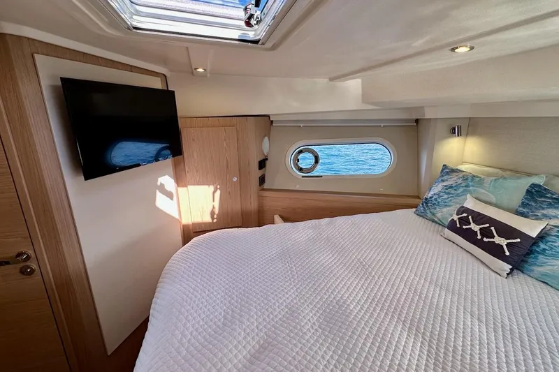 Slide: The Image of Luxurious bedroom interior of 2024 Beneteau Swift Trawler 41 Sedan with ocean view. - 64