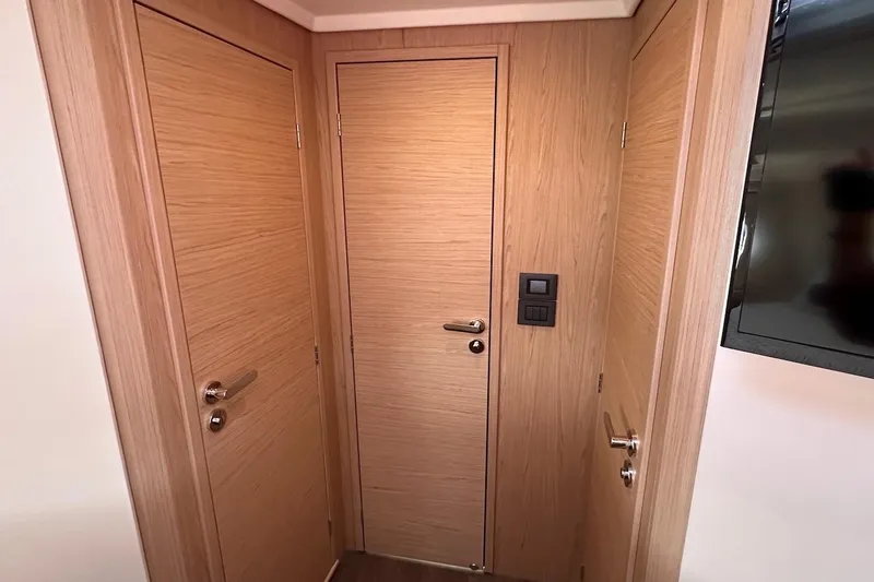 Slide: The Image of Interior of 2024 Beneteau Swift Trawler 41 Sedan with wooden doors and modern design. - 66