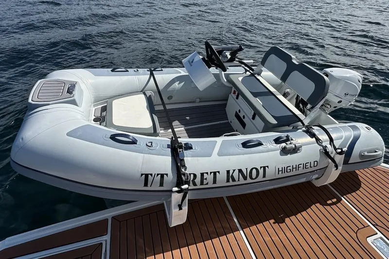 Slide: The Image of Highfield inflatable boat docked on water, featuring "T/T RET KNOT" text. - 86