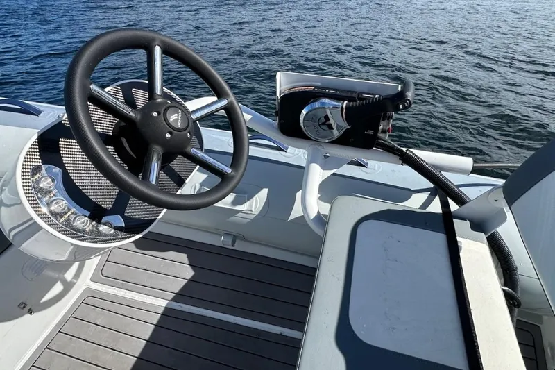Slide: The Image of Steering wheel and controls of 2024 Beneteau Swift Trawler 41 Sedan on water. - 89