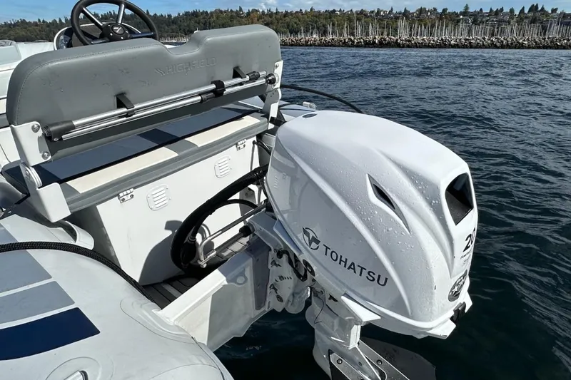 Slide: The Image of Tohatsu outboard motor on a 2024 Beneteau Swift Trawler 41 Sedan, docked by the shore. - 90