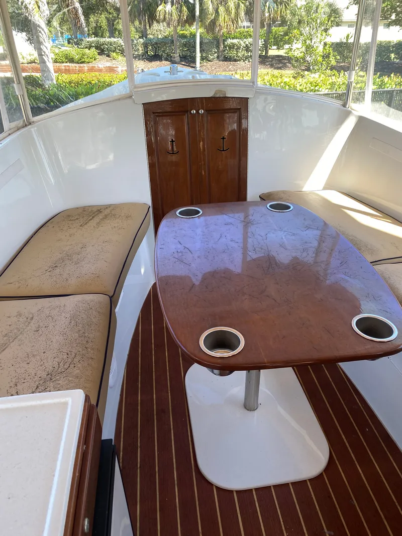 Slide: The Image of Interior of a 2017 Duffy 22 boat with wooden table. - 6