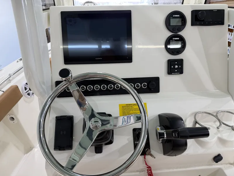 Slide: The Image of Key West 219FSR 2026 helm with Garmin display and controls. - 17