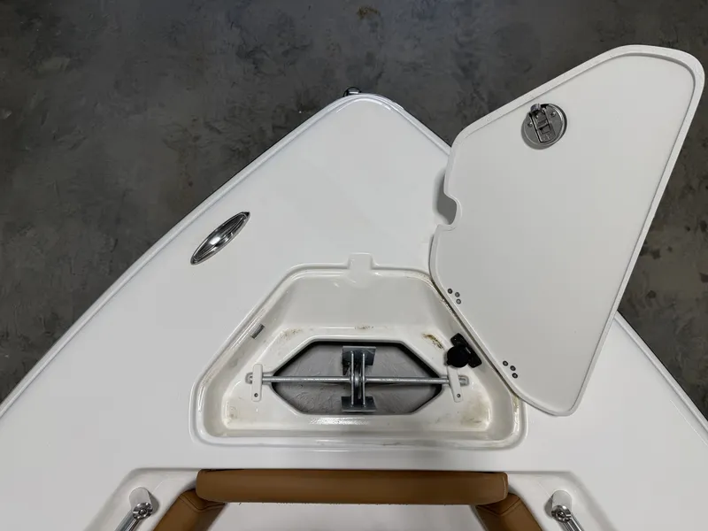 Slide: The Image of Key West 219FSR 2026 boat compartment with open storage hatch. - 24