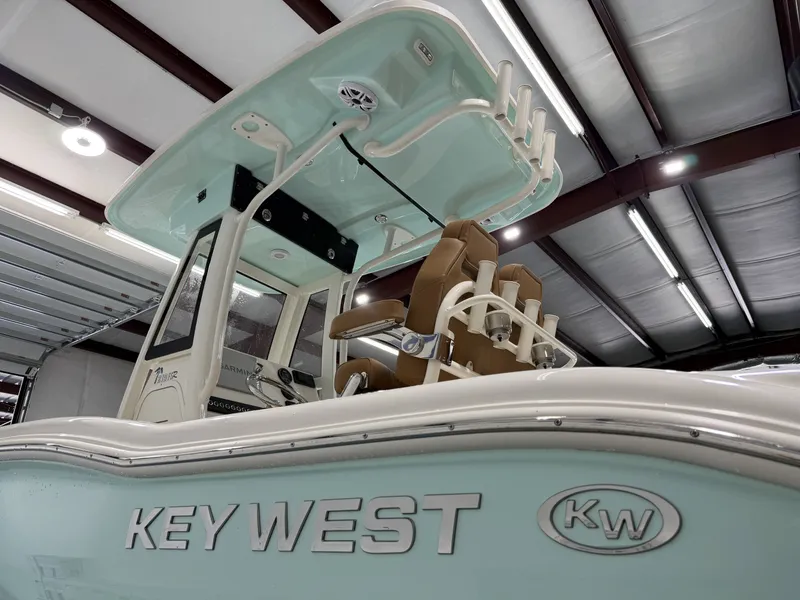Slide: The Image of Key West 219FSR 2026 boat indoors, side view. - 7