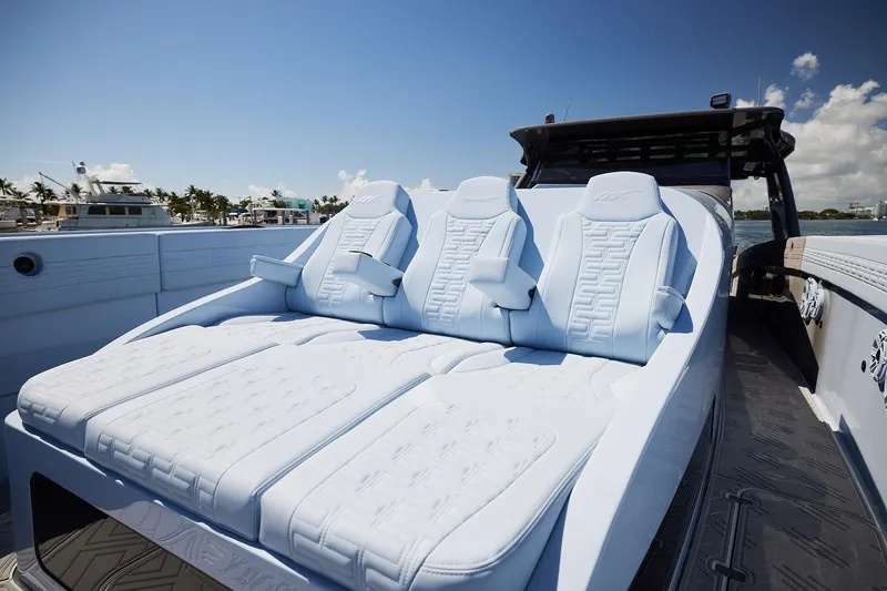 Slide: The Image of Luxurious seating on a Midnight Express 52 Vitesse boat under a clear blue sky. - 14