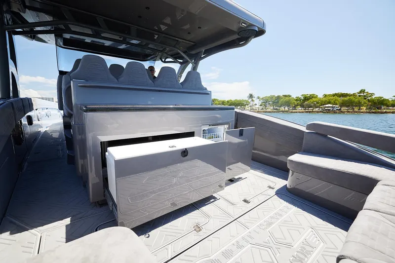 Slide: The Image of Luxurious interior of Midnight Express 52 Vitesse yacht with seating and storage, near scenic shoreline. - 19