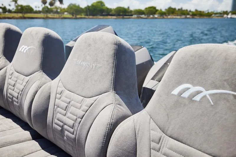 Slide: The Image of Luxurious seating on a Midnight Express 52 Vitesse boat, featuring Mansory branding. - 21