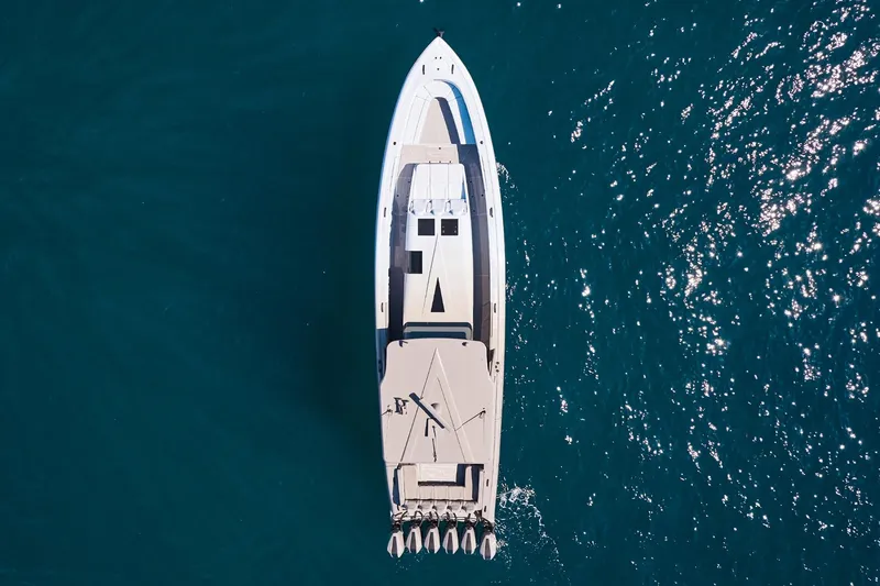 Slide: The Image of Aerial view of Midnight Express 52 Vitesse yacht cruising on blue ocean waters. - 6