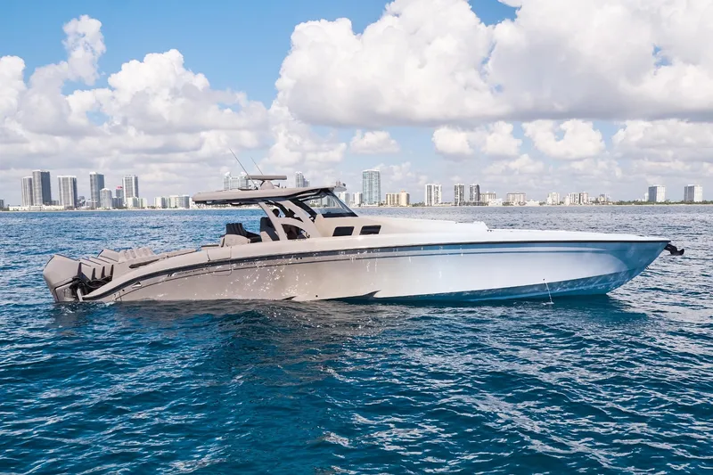 Slide: The Image of Midnight Express 52 Vitesse yacht cruising on blue ocean with city skyline backdrop. - 7