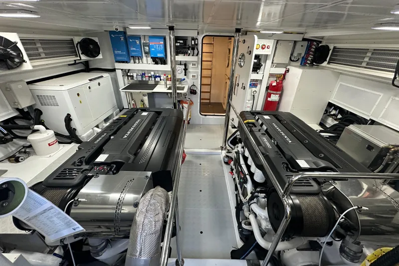 Slide: The Image of Engine room of 2027 Hunt Yachts 63 Flybridge, featuring twin engines and modern equipment. - 12