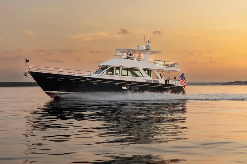 Slide: The Image of 2027 Hunt Yachts 63 Flybridge cruising at sunset on calm waters. - 13