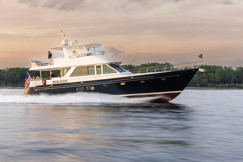 Slide: The Image of 2027 Hunt Yachts 63 Flybridge cruising on calm waters at sunset. - 14