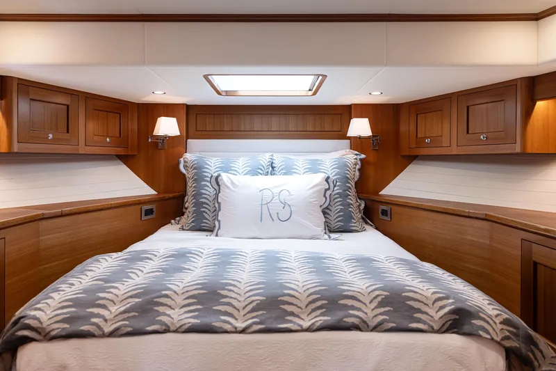 Slide: The Image of Luxurious cabin interior of 2027 Hunt Yachts 63 Flybridge with elegant bedding and wood finish. - 6