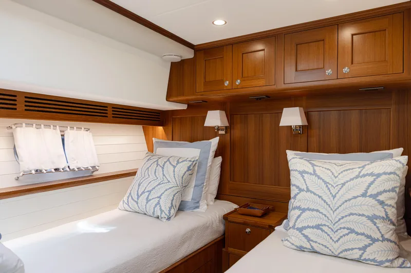 Slide: The Image of Luxurious cabin interior of 2027 Hunt Yachts 63 Flybridge with elegant wood paneling and cozy bedding. - 7