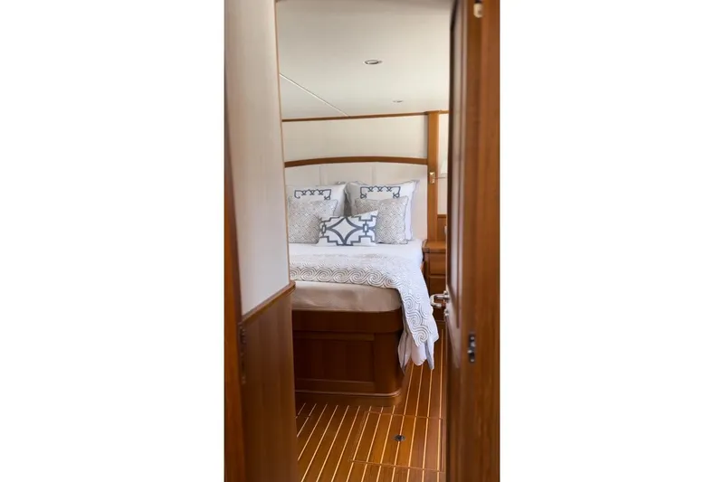 Slide: The Image of Luxurious bedroom interior of 2027 Hunt Yachts 63 Flybridge with elegant bedding and wood finish. - 9