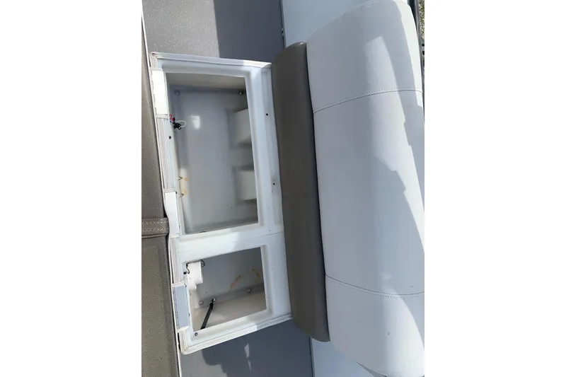 Slide: The Image of Open storage compartment on a 2019 YAMAHA G3 V22FC boat seat. - 16