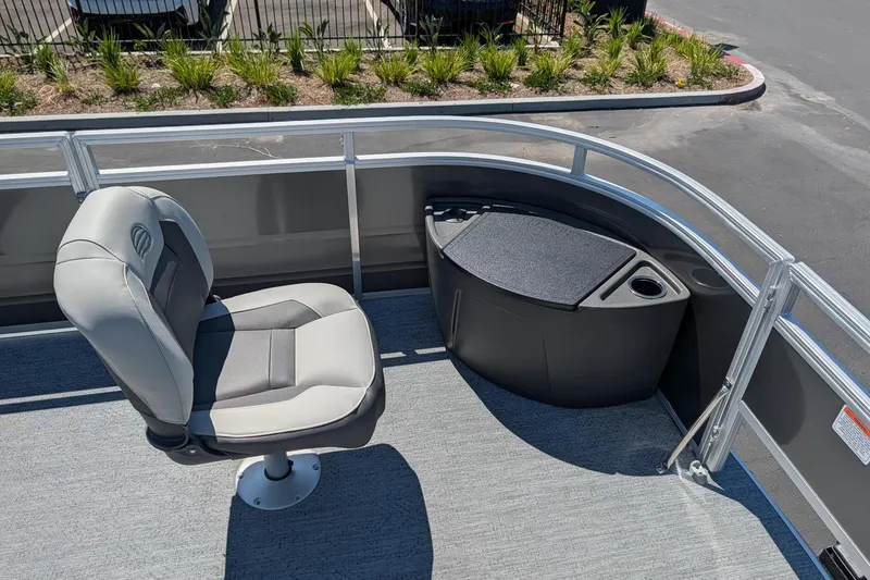 Slide: The Image of 2026 Sun Tracker Fishin' Barge 22 DLX interior with seating and storage. - 12