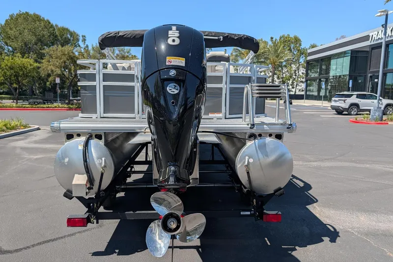 Slide: The Image of 2026 Sun Tracker Fishin' Barge 22 DLX pontoon boat with powerful outboard motor. - 4
