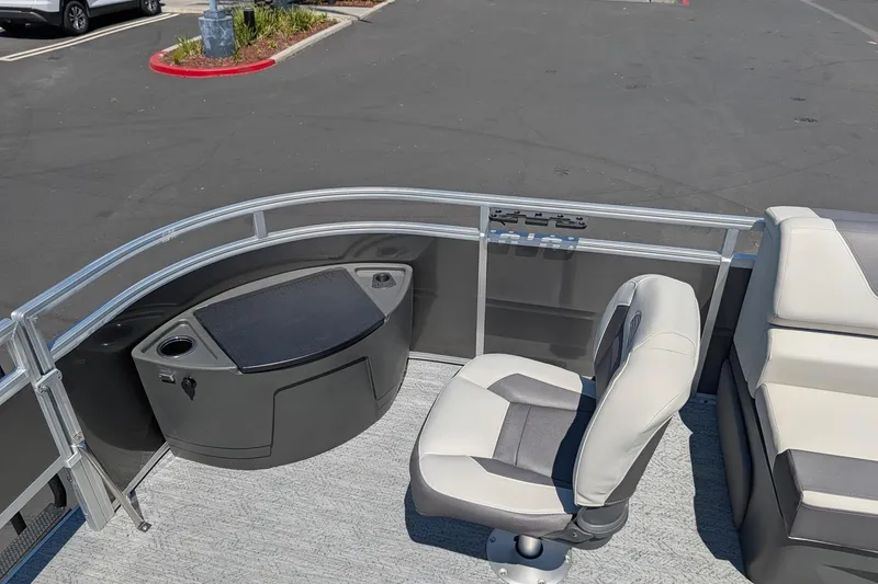 Slide: The Image of 2026 Sun Tracker Fishin' Barge 22 DLX interior with seating and storage features. - 9