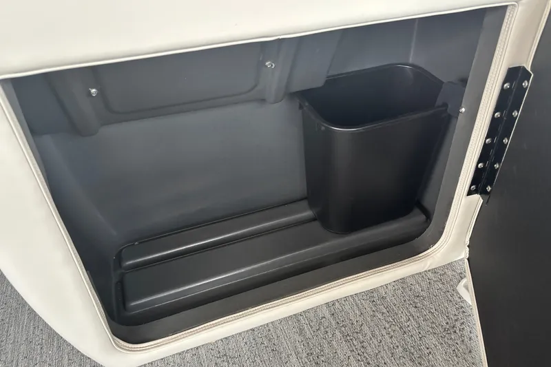 Slide: The Image of Storage compartment with trash bin in 2026 Sun Tracker Fishin' Barge 22 DLX. - 31
